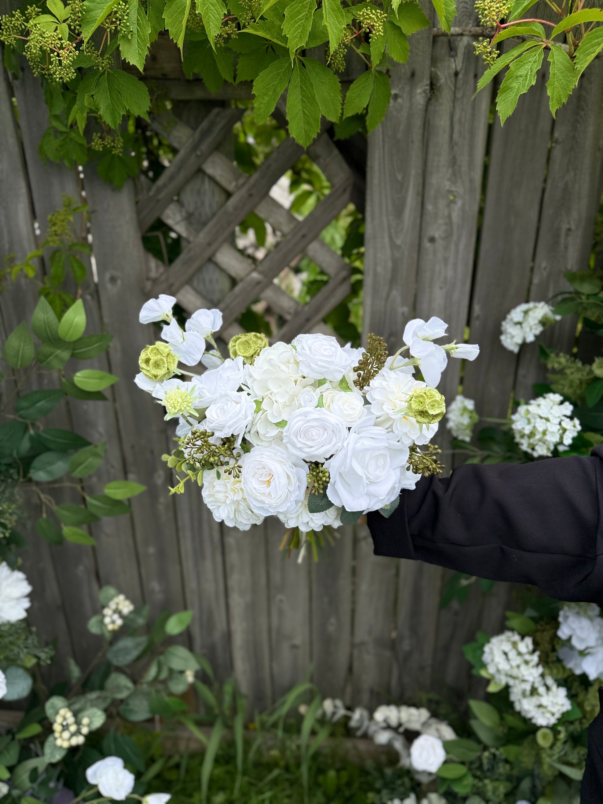 Classic modern faux white bridal bouquet with roses, dahlias, hydrangeas, scabiosa balls and berries 